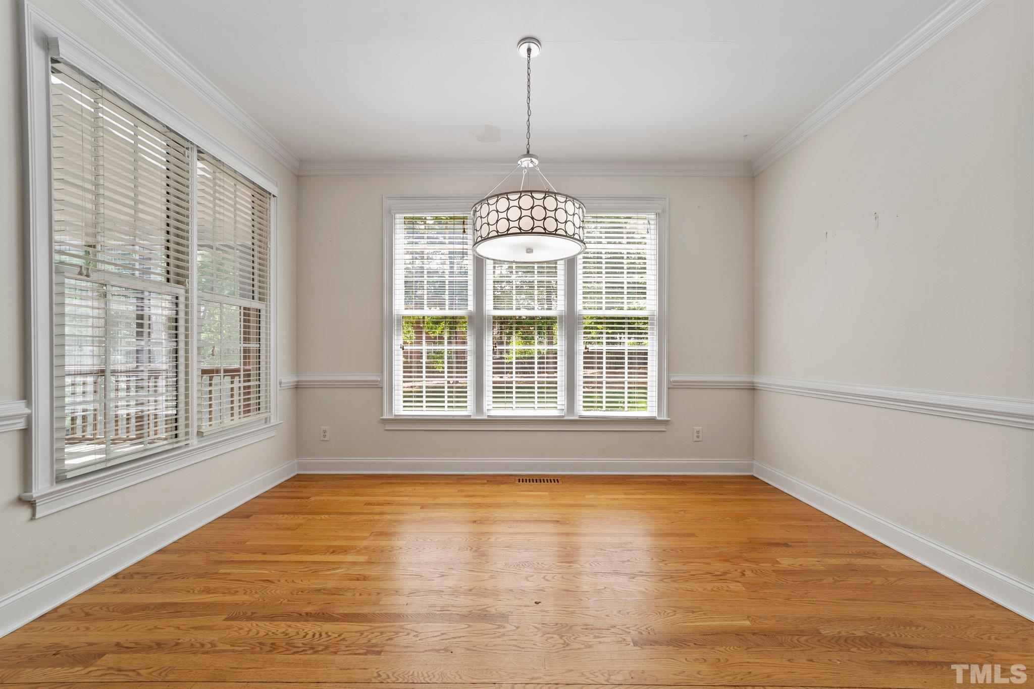 4012 Grandbridge Drive Apex, NC 27539 - Photo 23 of 51 a view of an empty room with wooden floor and a window