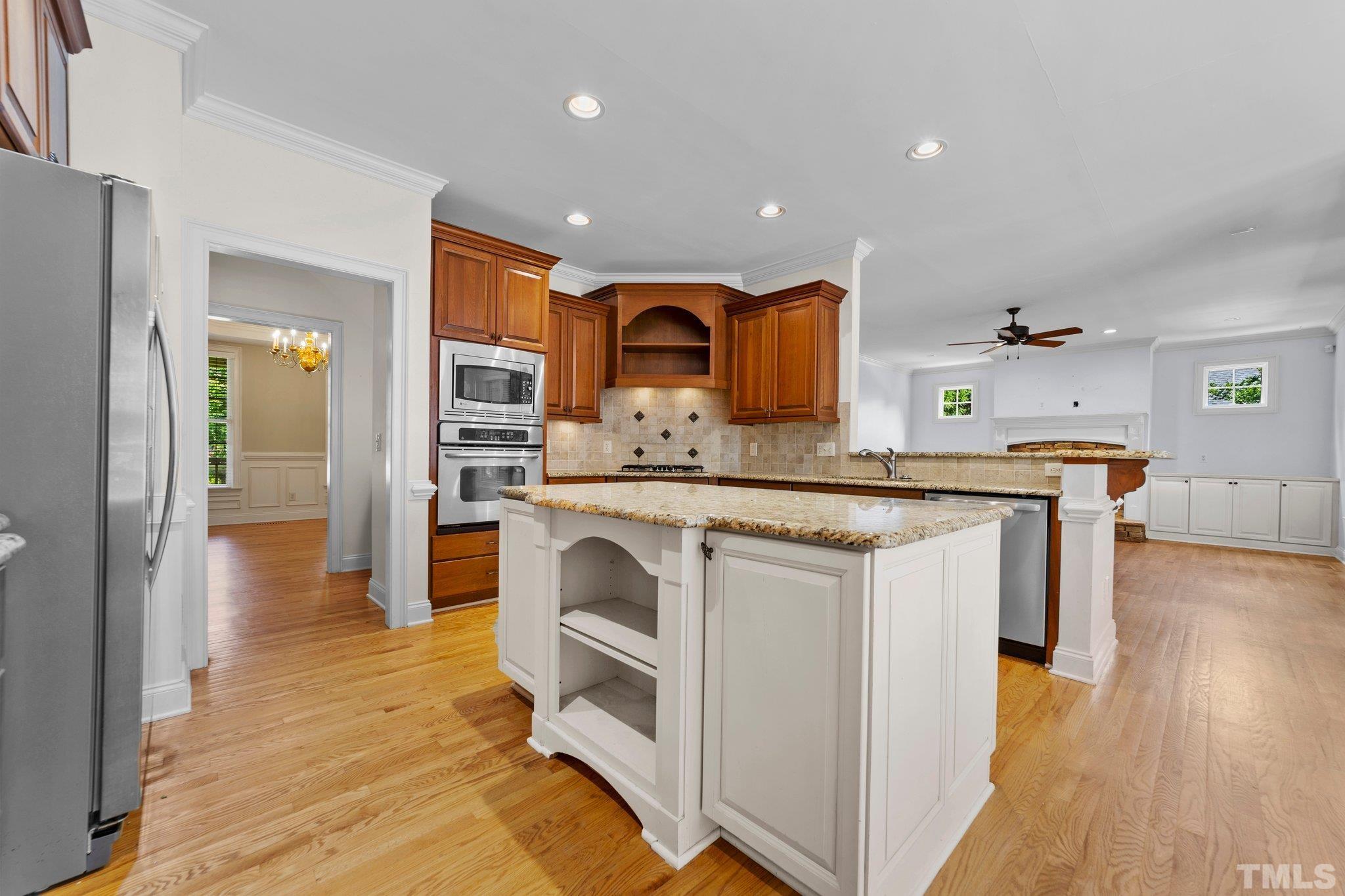 4012 Grandbridge Drive Apex, NC 27539 - Photo 25 of 51 a kitchen with stainless steel appliances granite countertop a stove and a sink