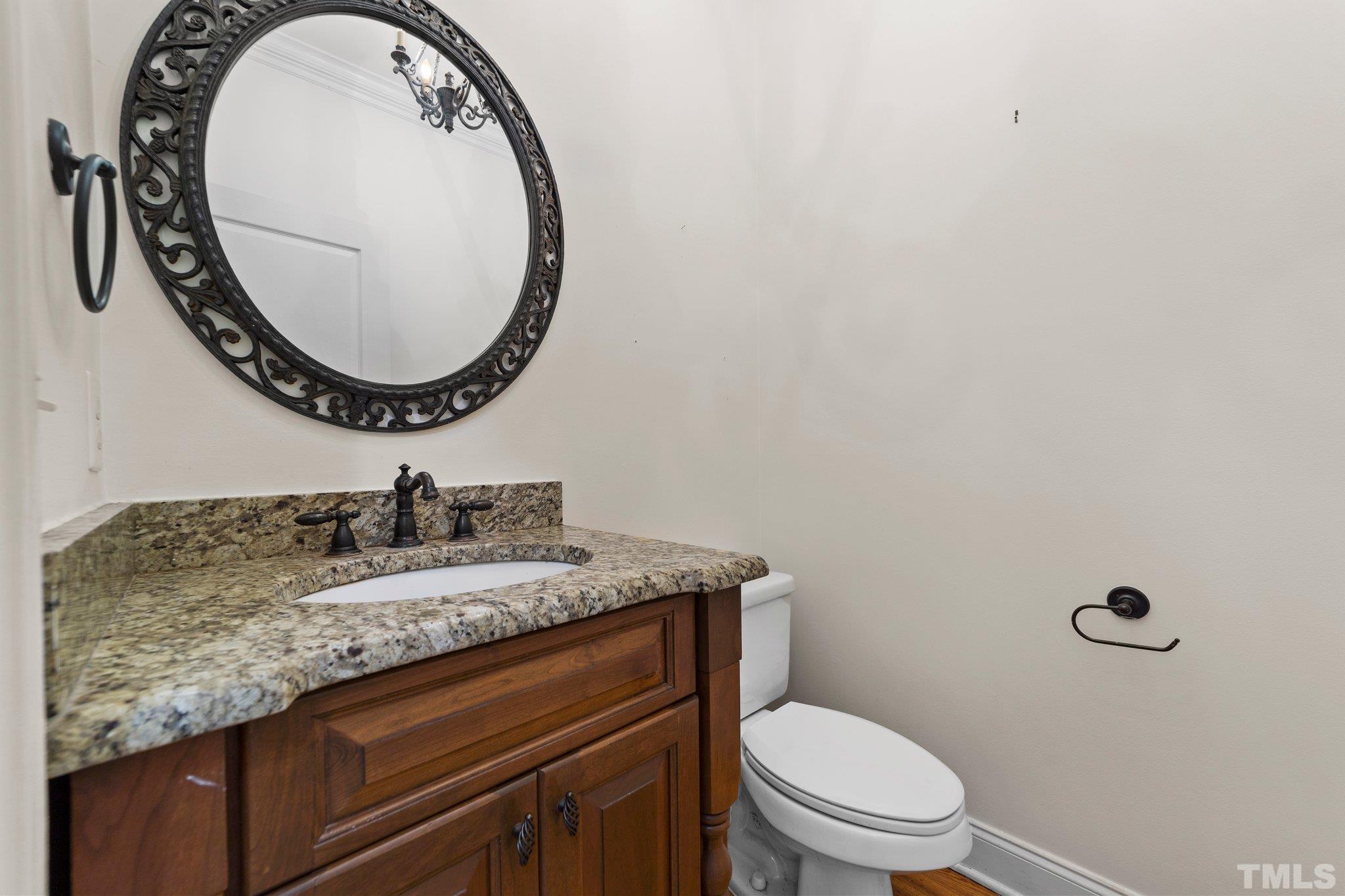 4012 Grandbridge Drive Apex, NC 27539 - Photo 28 of 51 a bathroom with a granite countertop toilet sink mirror and vanity