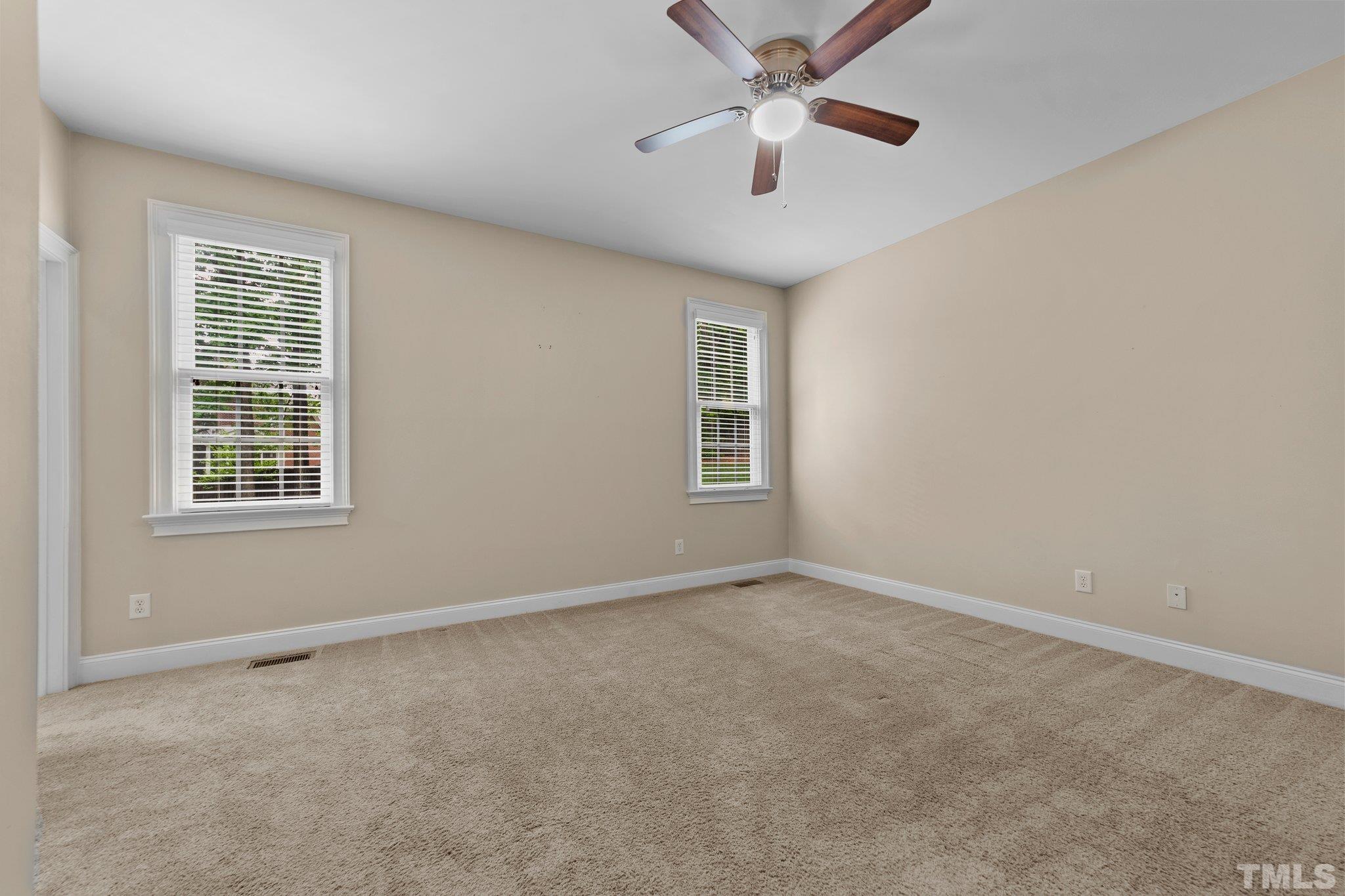 4012 Grandbridge Drive Apex, NC 27539 - Photo 29 of 51 an empty room with windows and fan