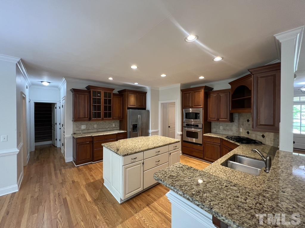 4012 Grandbridge Drive Apex, NC 27539 - Photo 3 of 51 a kitchen with stainless steel appliances granite countertop a sink stove and refrigerator