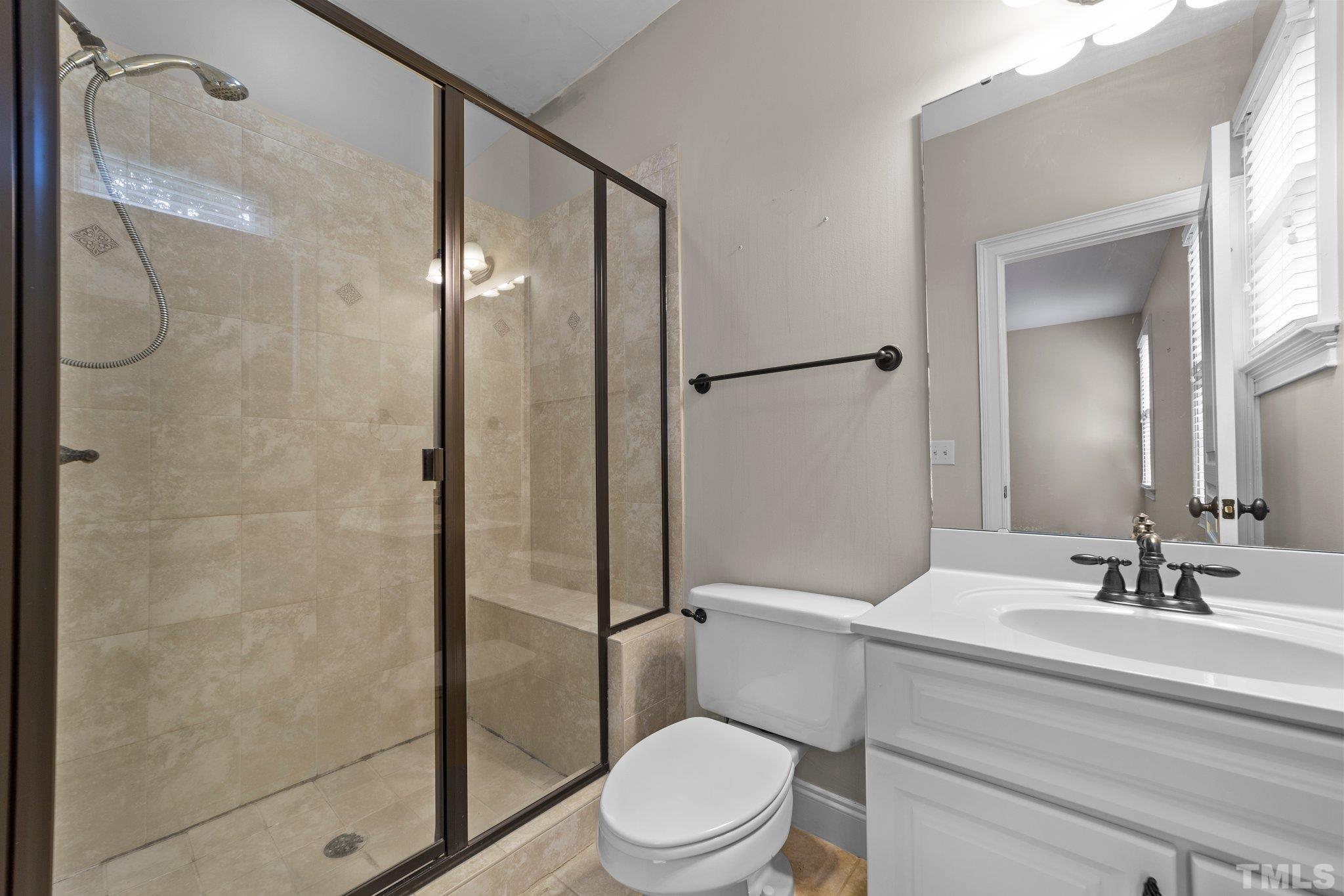 4012 Grandbridge Drive Apex, NC 27539 - Photo 32 of 51 a bathroom with a sink a toilet and shower