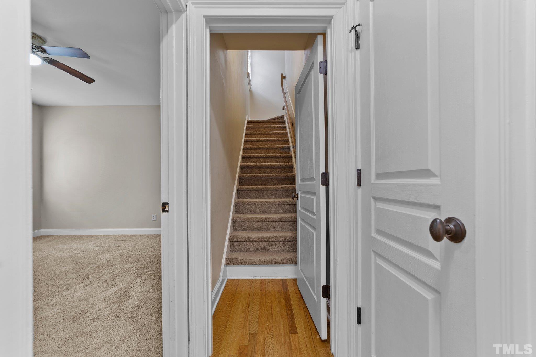 4012 Grandbridge Drive Apex, NC 27539 - Photo 33 of 51 a view of a hallway with wooden floor and staircase