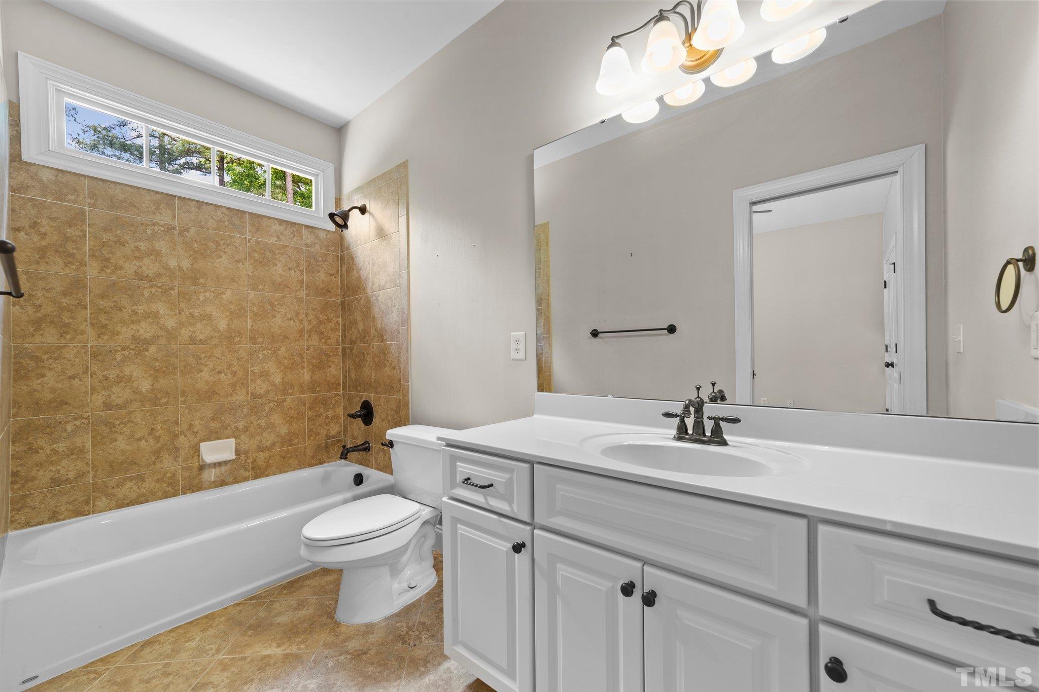 4012 Grandbridge Drive Apex, NC 27539 - Photo 38 of 51 a bathroom with a sink a toilet and a bathtub