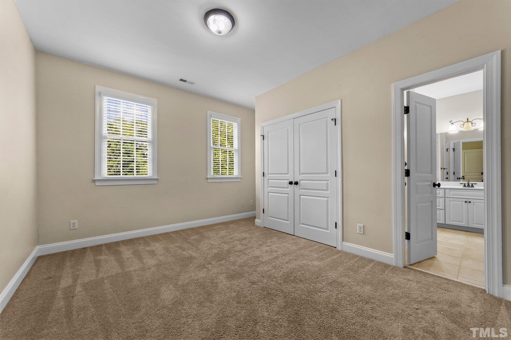 4012 Grandbridge Drive Apex, NC 27539 - Photo 39 of 51 an empty room with windows and closet