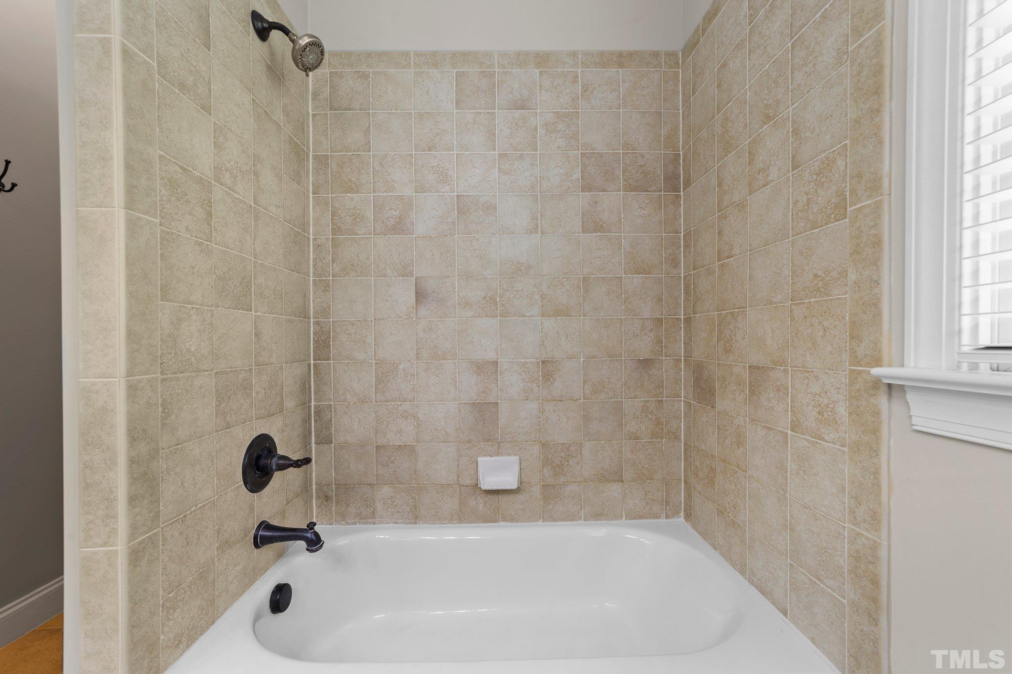 4012 Grandbridge Drive Apex, NC 27539 - Photo 41 of 51 a bathroom with a bathtub
