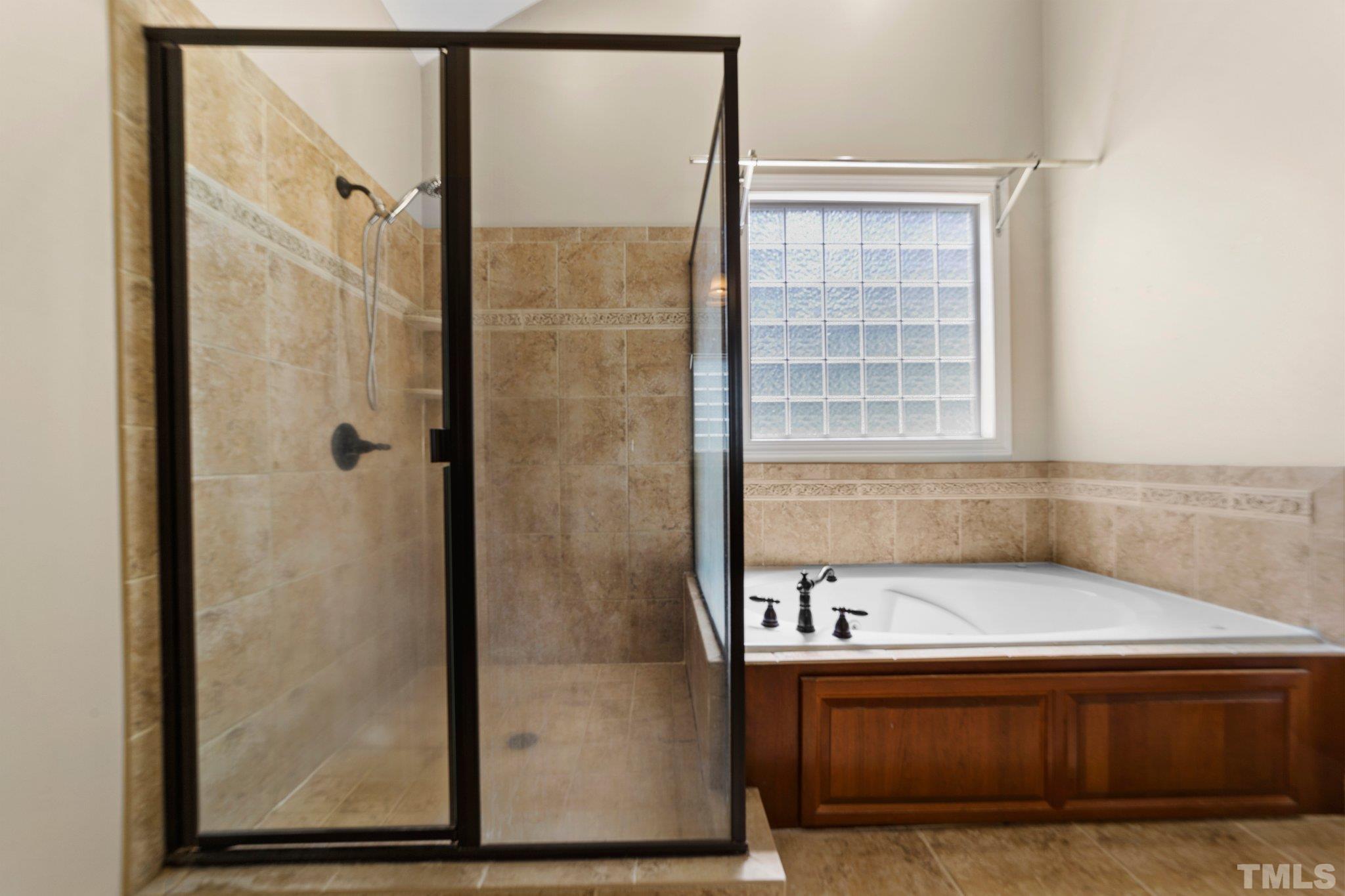 4012 Grandbridge Drive Apex, NC 27539 - Photo 45 of 51 a bathroom with a tub and a shower