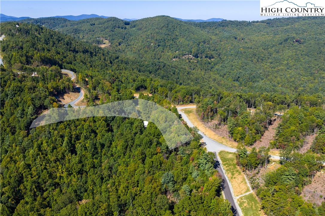 Lot 137 Angelfire Trail Deep Gap, NC 28618 - Photo 15 of 27 an aerial view of green landscape with trees houses and mountain view