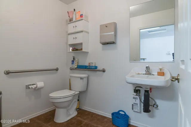 a bathroom with a sink toilet and a mirror