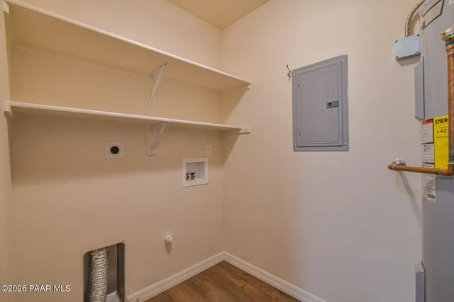 a view of a livingroom with a ceiling fan & wooden floor