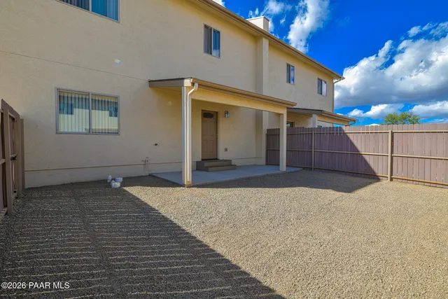 a backyard of a house with table and chairs