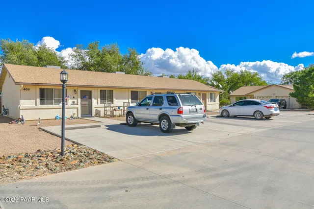 a view of cars parked in front of a house