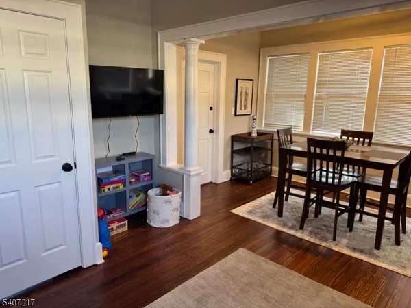 a view of a dining room with furniture and wooden floor