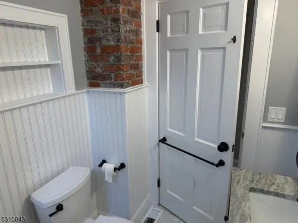 a bathroom with a granite countertop sink