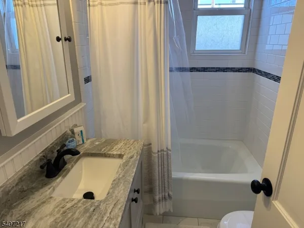 a bathroom with a tub and a sink