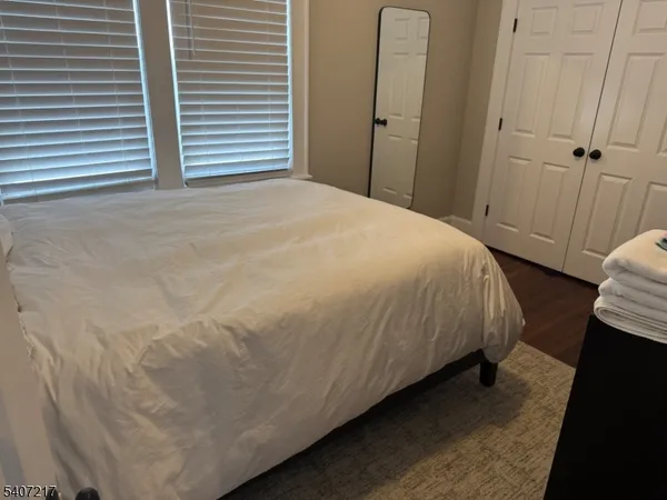 a bed sitting in a bedroom next to a bathroom