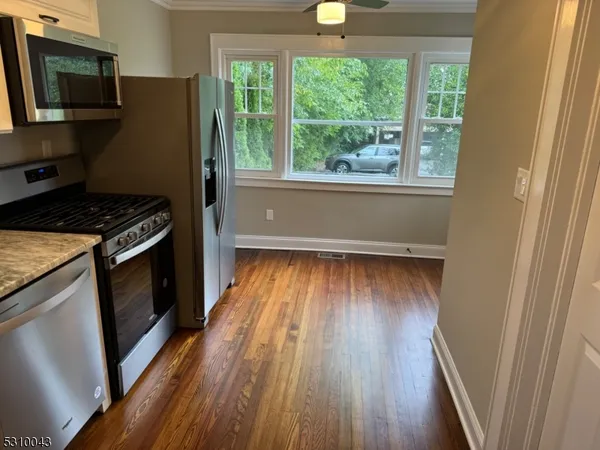 a kitchen with wooden floors and a stove