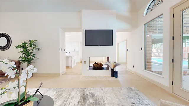 a large white kitchen with stainless steel appliances kitchen island granite countertop a refrigerator and a stove top oven