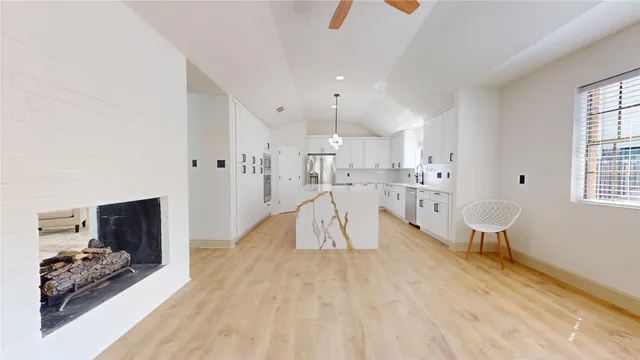 a view of a hallway with wooden floor and a cabinet