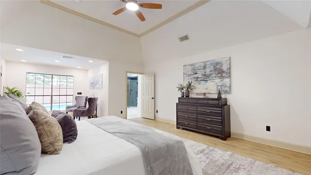 a bedroom with a bed and a potted plant