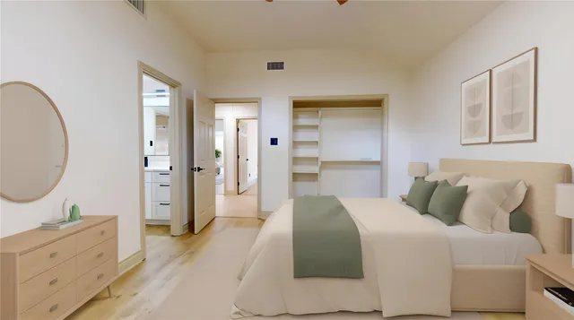 a bedroom with a bed and a chandelier