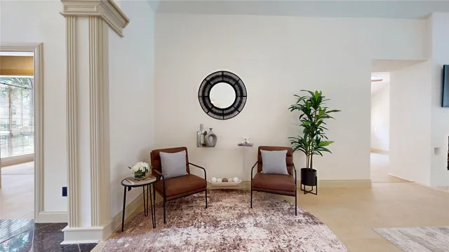 a living room with furniture and white walls