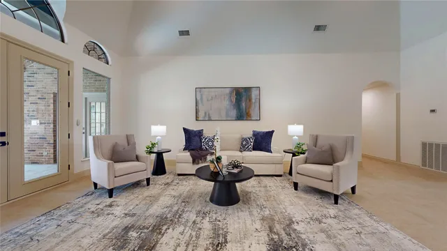 a living room with furniture chandelier and a fireplace