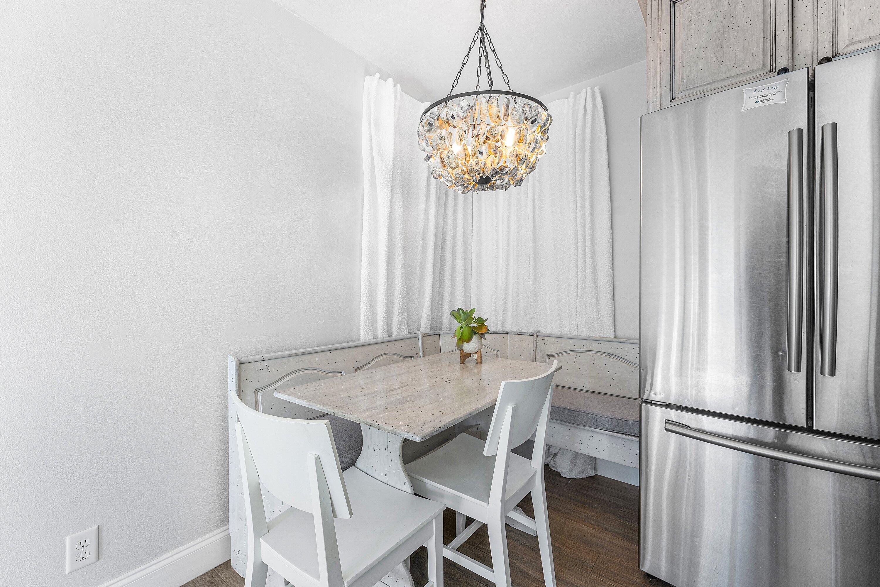 817 Buttonwood Road North Palm Beach, FL 33408 - Photo 12 of 39 a view of a dining area with furniture window and wooden floor