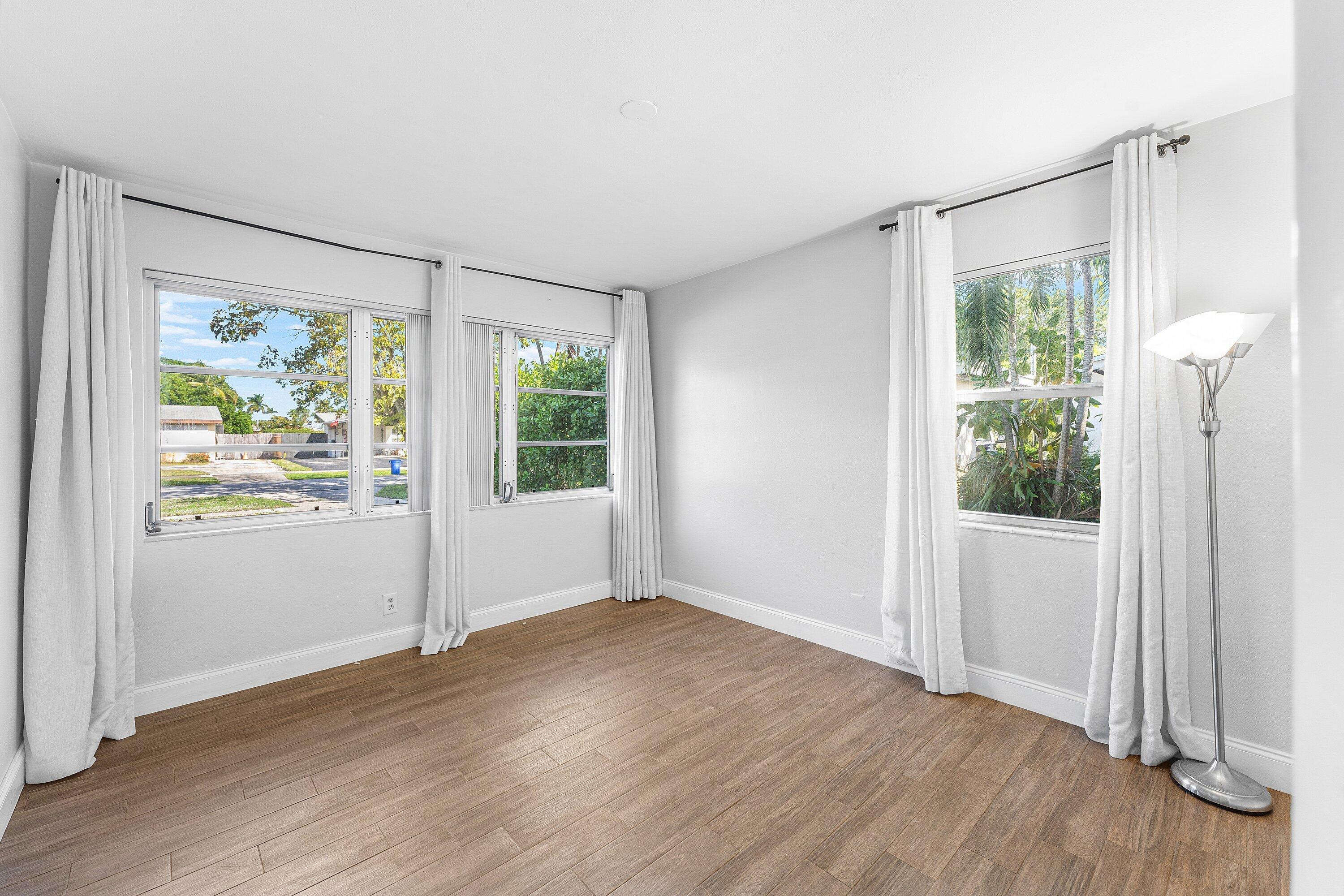 817 Buttonwood Road North Palm Beach, FL 33408 - Photo 13 of 39 a view of an empty room with wooden floor and a window