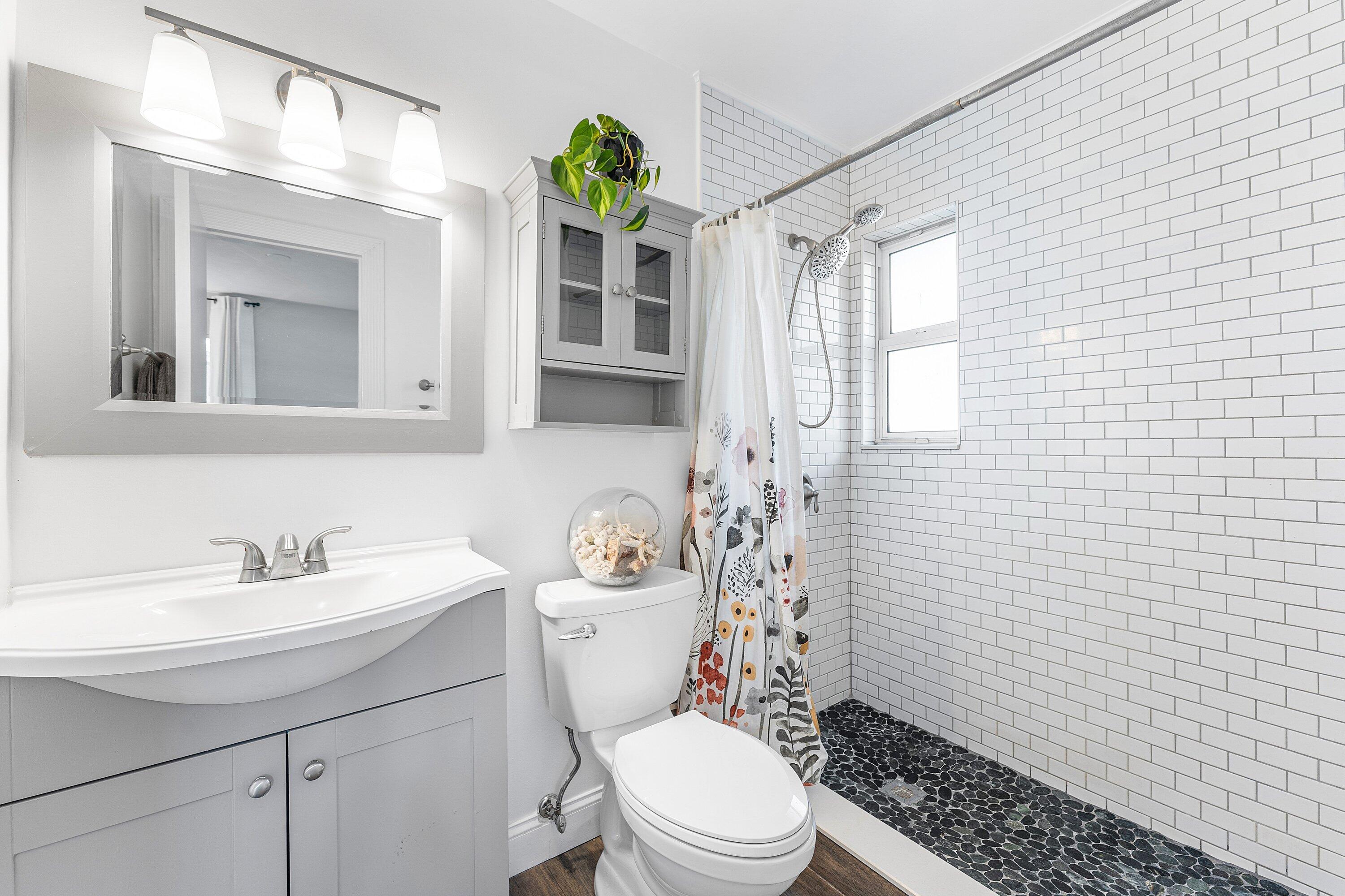 817 Buttonwood Road North Palm Beach, FL 33408 - Photo 15 of 39 a bathroom with a sink a toilet and shower