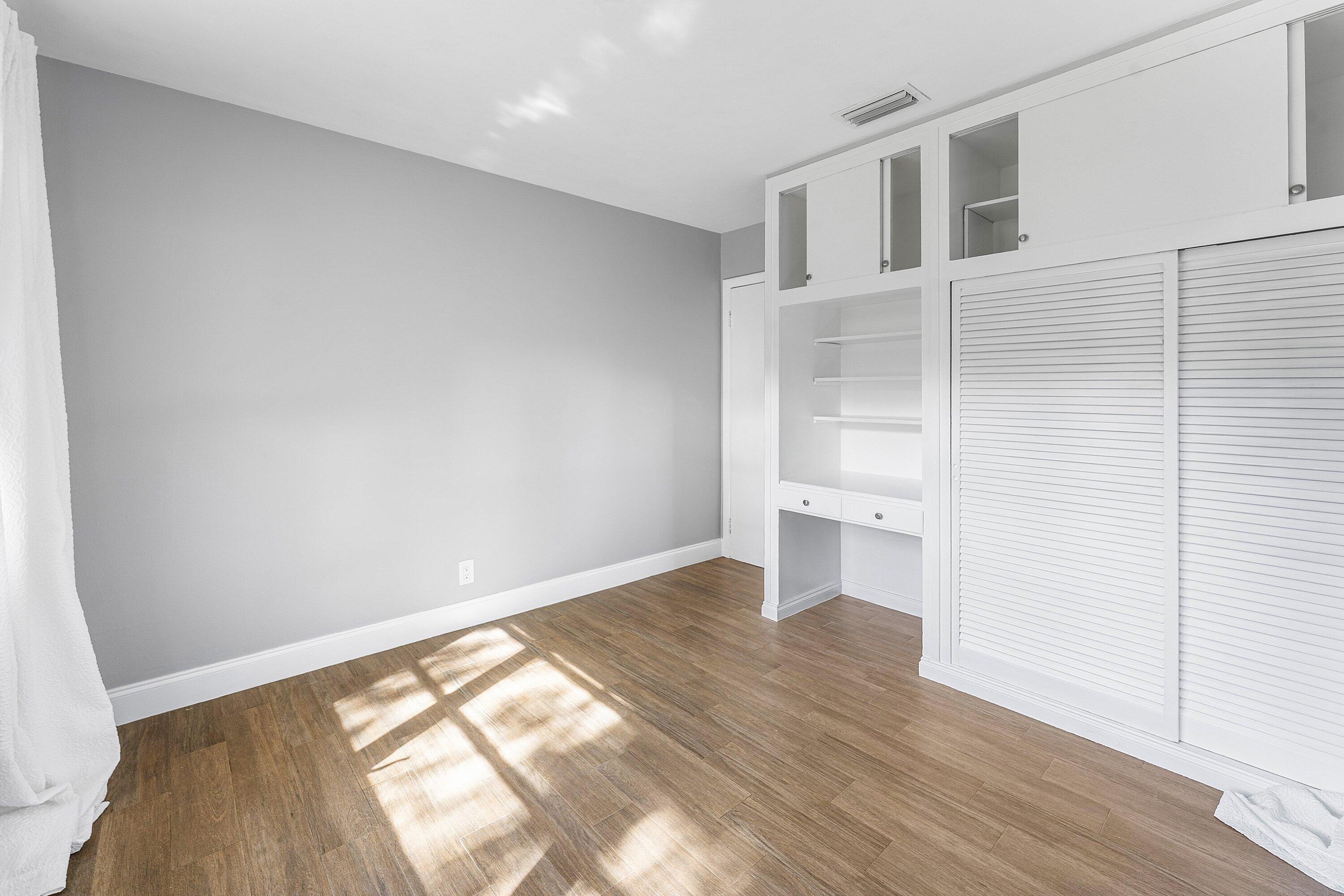 817 Buttonwood Road North Palm Beach, FL 33408 - Photo 17 of 39 a view of an empty room with wooden floor and a window