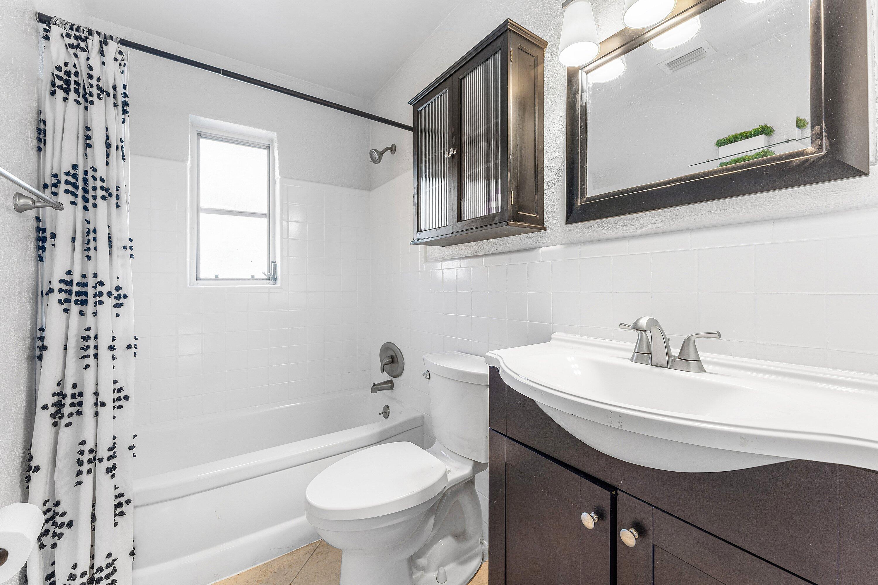 817 Buttonwood Road North Palm Beach, FL 33408 - Photo 18 of 39 a bathroom with a sink a toilet and shower