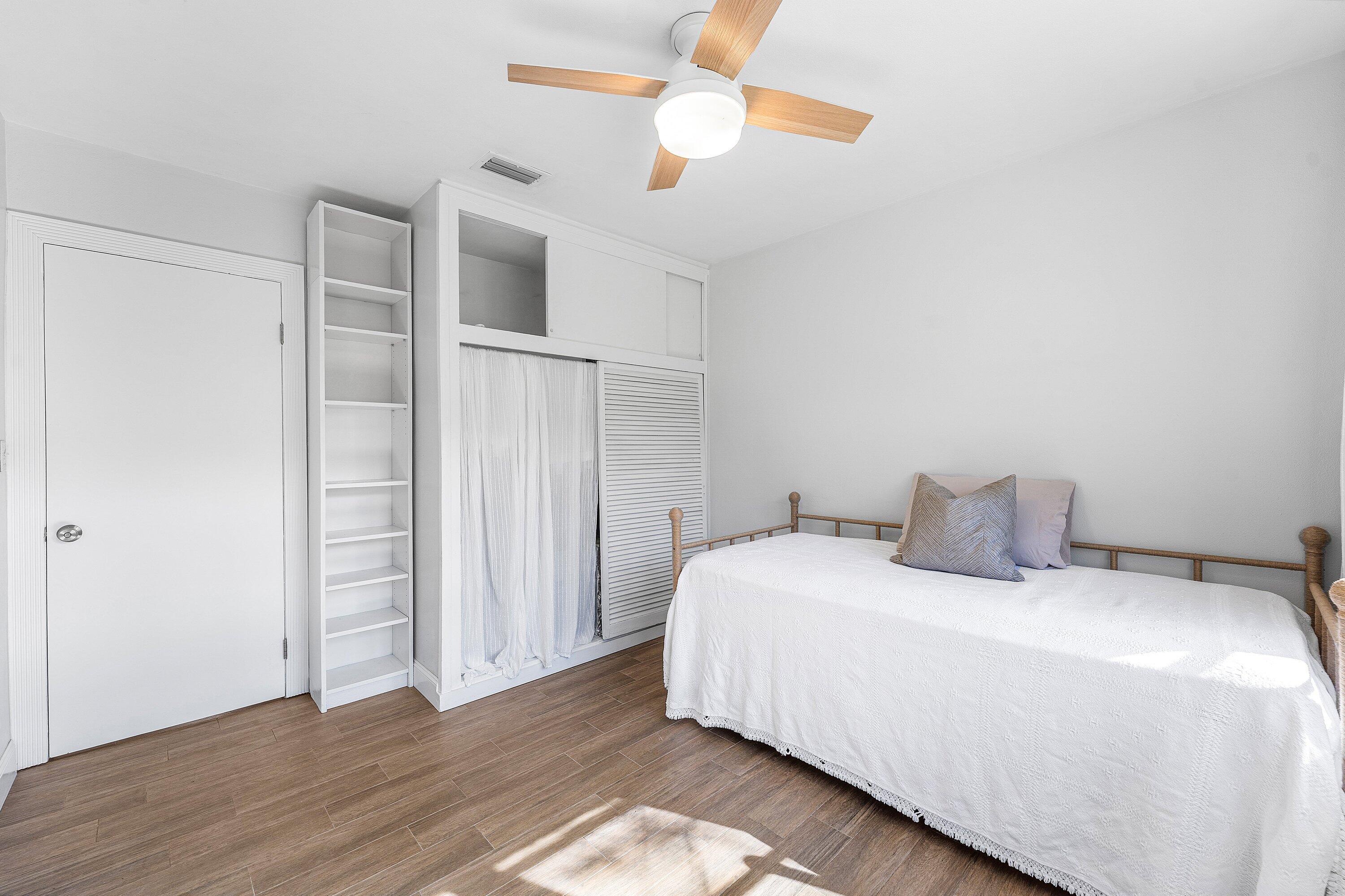 817 Buttonwood Road North Palm Beach, FL 33408 - Photo 20 of 39 a bedroom with a bed and wooden floor