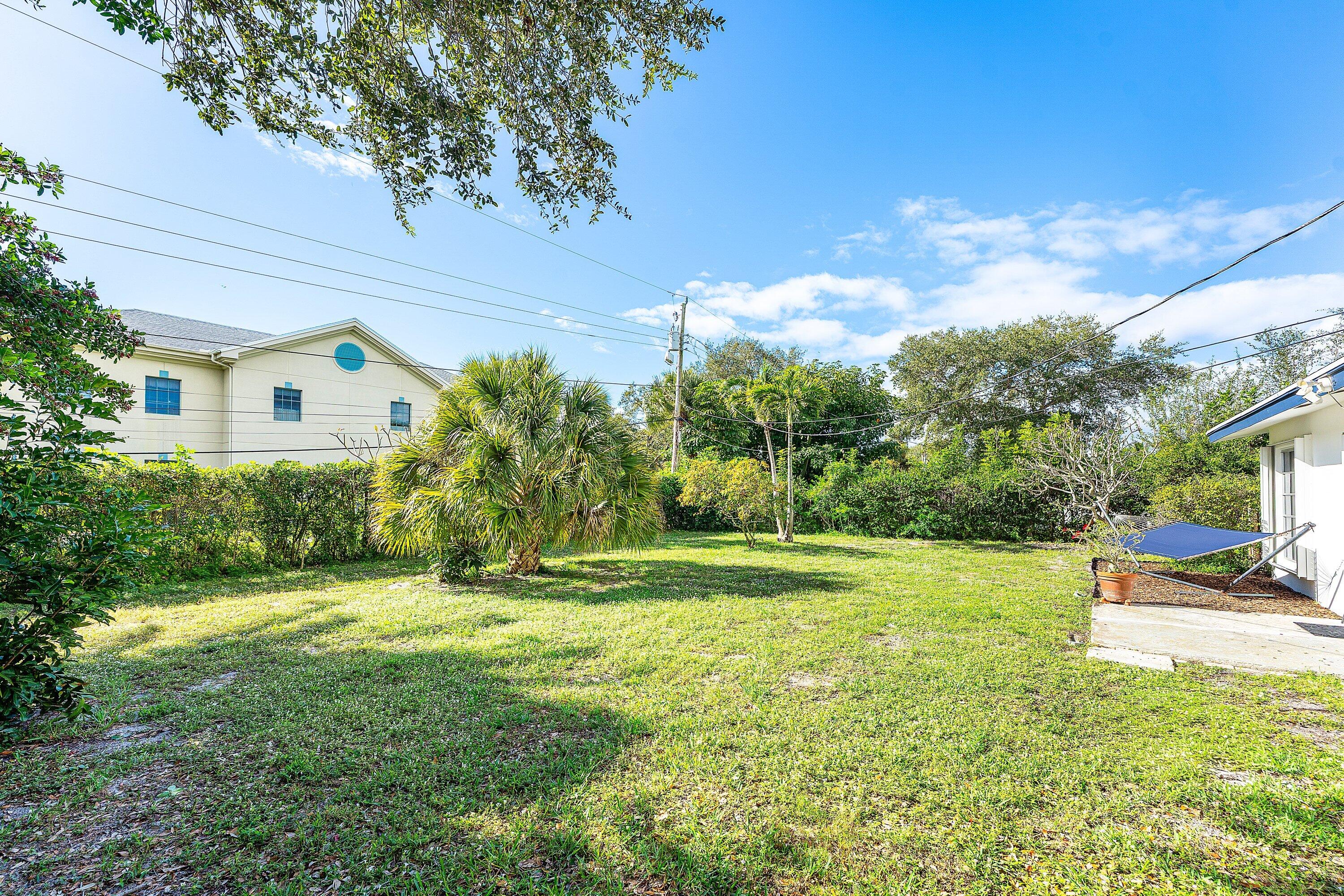 817 Buttonwood Road North Palm Beach, FL 33408 - Photo 24 of 39 a view of a house with a big yard and potted plants