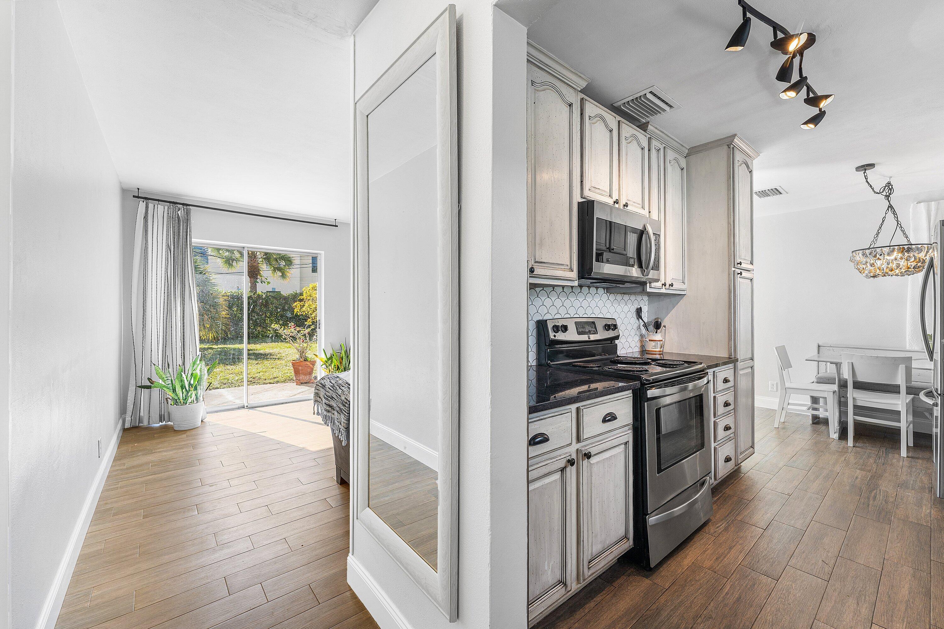 817 Buttonwood Road North Palm Beach, FL 33408 - Photo 4 of 39 a kitchen with a stove a sink and a refrigerator
