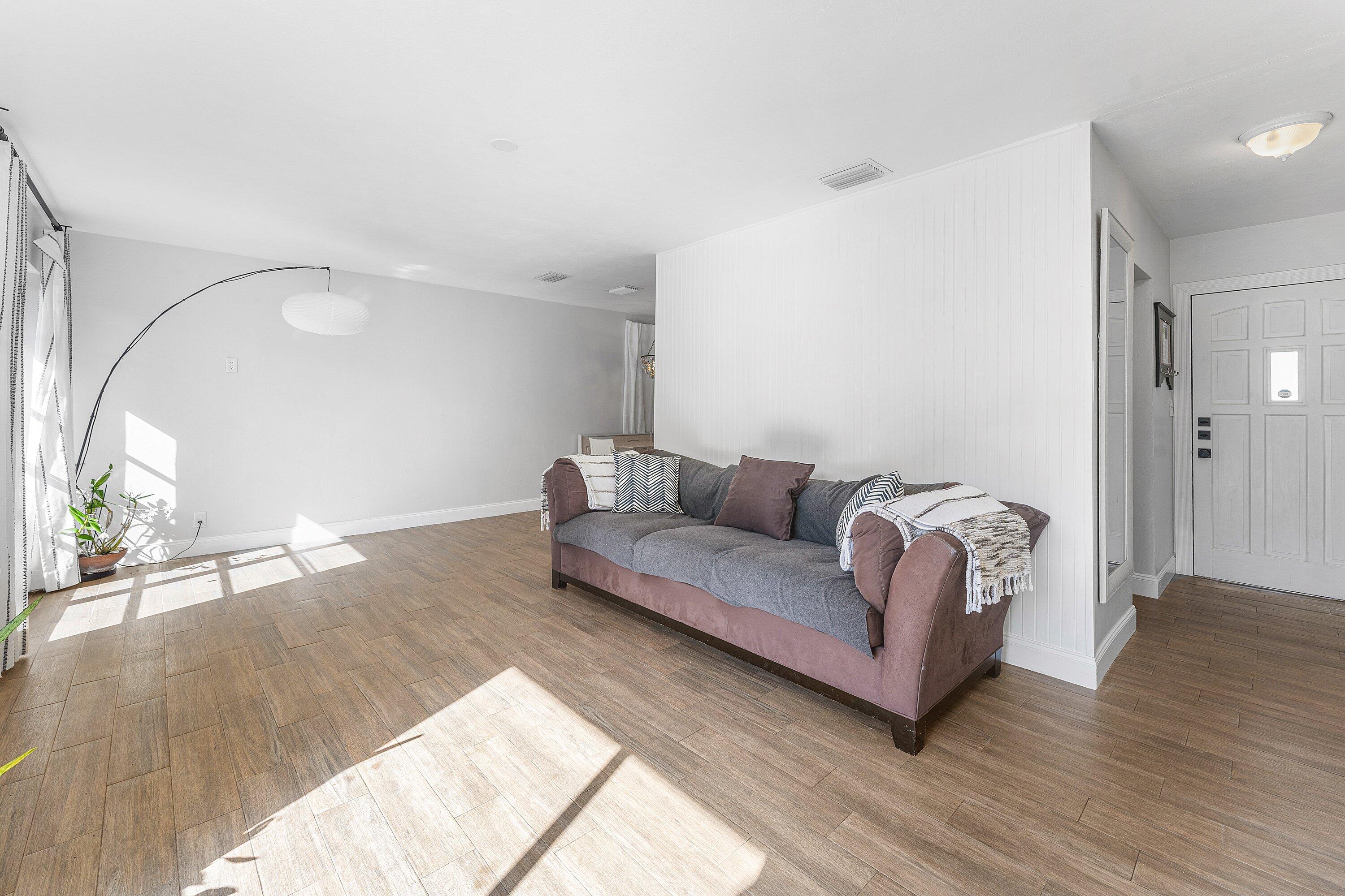 817 Buttonwood Road North Palm Beach, FL 33408 - Photo 6 of 39 a living room with furniture and a wooden floor