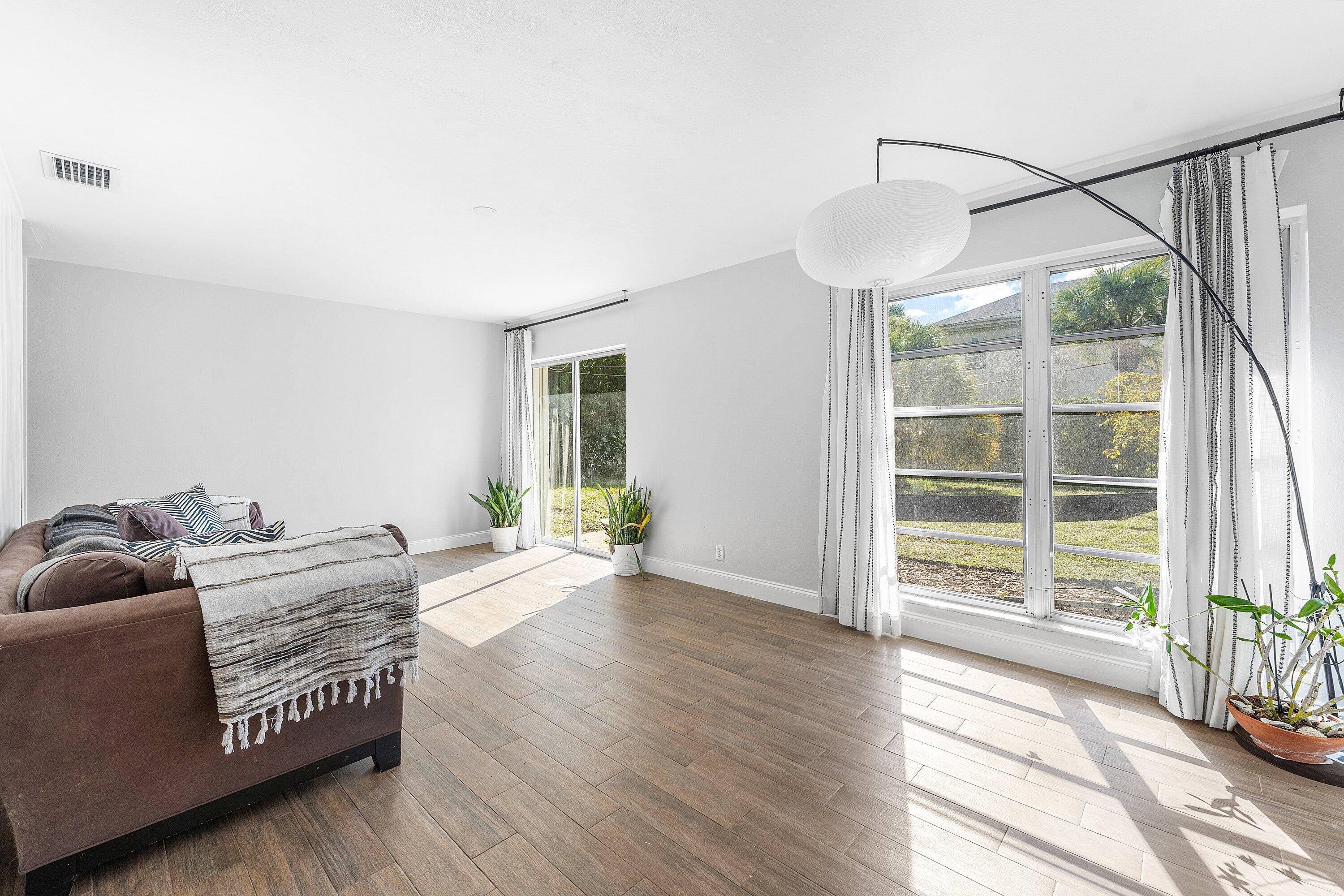 817 Buttonwood Road North Palm Beach, FL 33408 - Photo 8 of 39 a living room with furniture and a large window