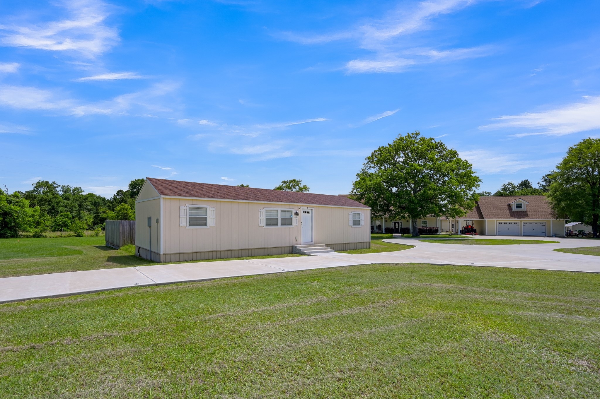 144 Wood Farm Road Huntsville, TX 77320 - Photo 32 of 35 a front view of a house with a yard and garage