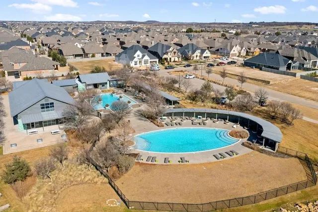 a front view of a house with a yard and potted plants