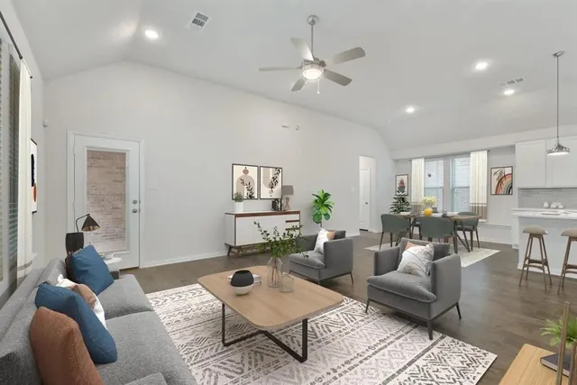 a living room with furniture and a wooden floor