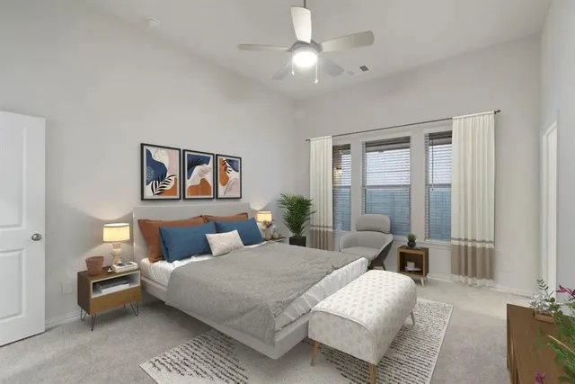 a bedroom with a large bed and a chandelier