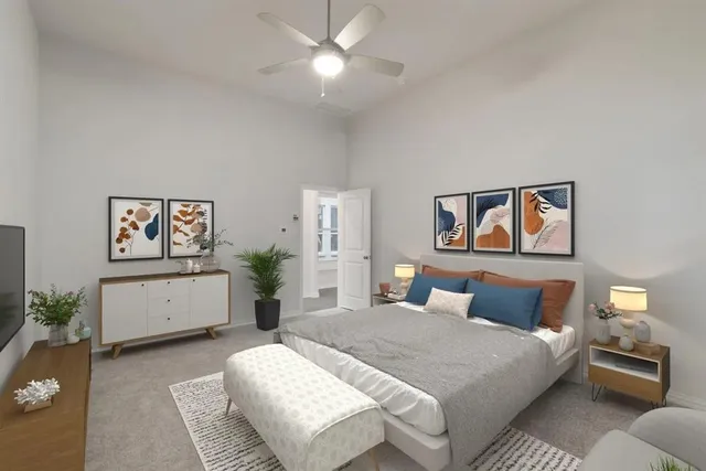 a bedroom with a large bed and paintings on the wall