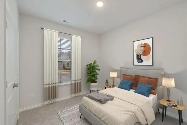 a bedroom with a bed and a painting on the wall