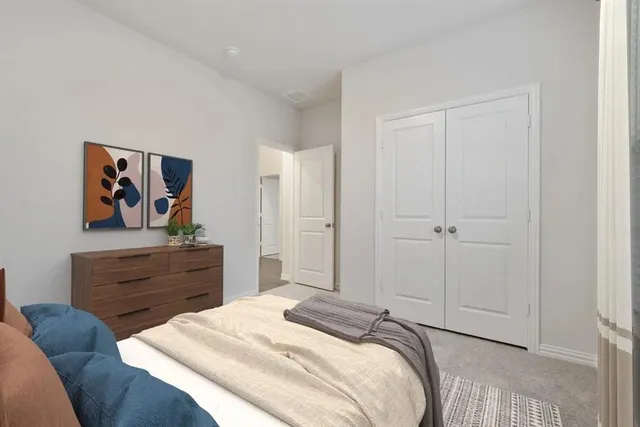 a bedroom with a bed and painting on the wall