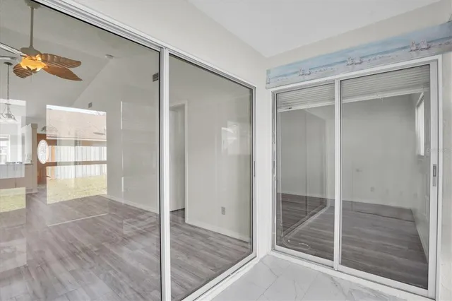 a view of a room with wooden floor and windows
