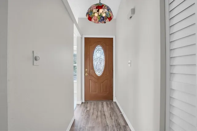 a view of a hallway with wooden floor