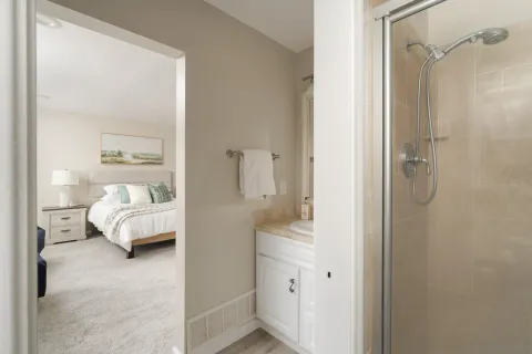 a en suite bathroom with a double vanity sink and a mirror