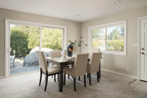 a view of a dining room with furniture window and outside view