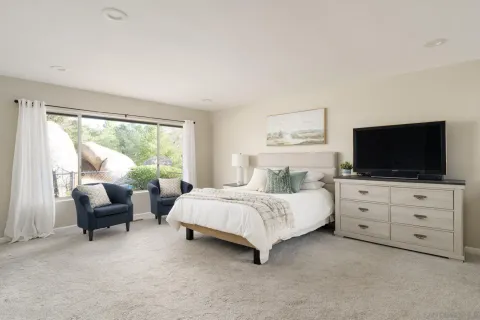 a room with a bed and a flat screen tv