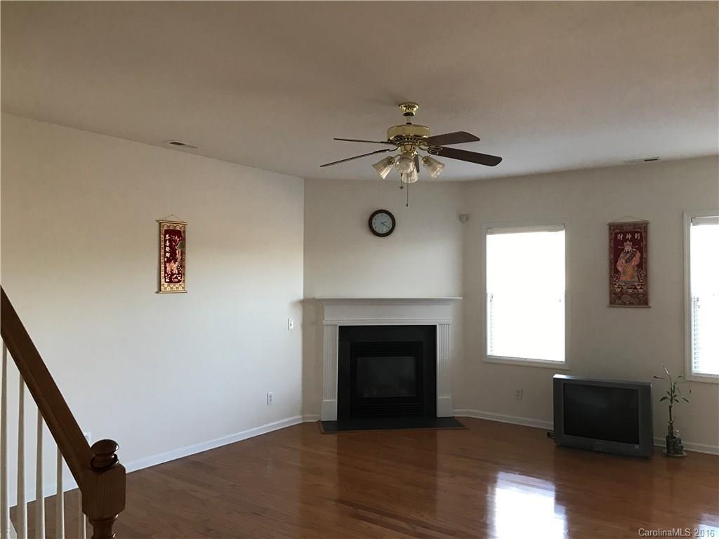 6412 Trotters Ridge Road Charlotte, NC 28227 - Photo 3 of 20 a view of an empty room with a fireplace and a window